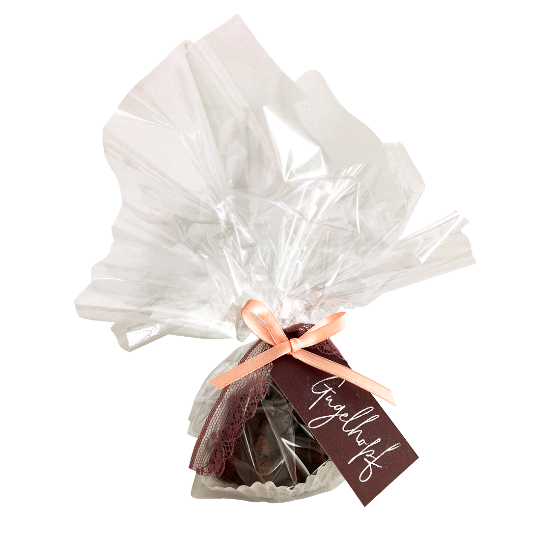 In Klarsichtfolie verpacktes Gugelhöpfli mit apricotfarbener Schleife und Anhänger